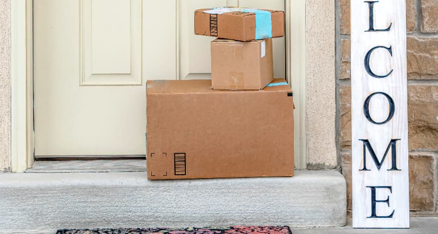 Deliveries on the front porch of a house with a welcome sign in Boulder